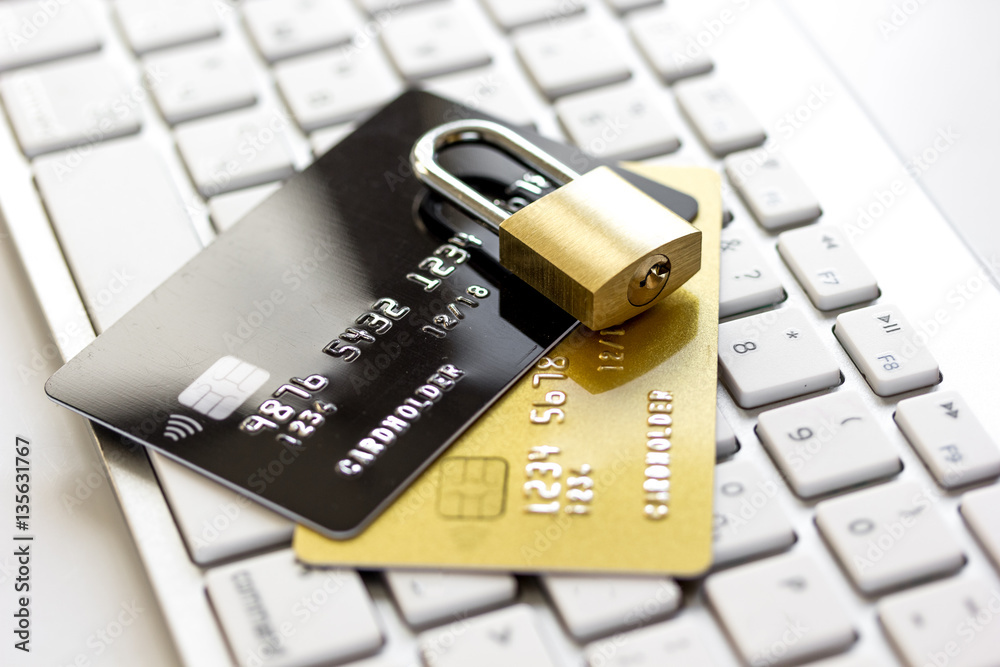 Credit cards on the keyboard with lock close up Credit cards on the keyboard with lock close up
