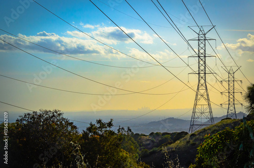 Sunset in the mountains over power lines with downtown Los Angeles skyline ithe the background. © Mary Lynn Strand