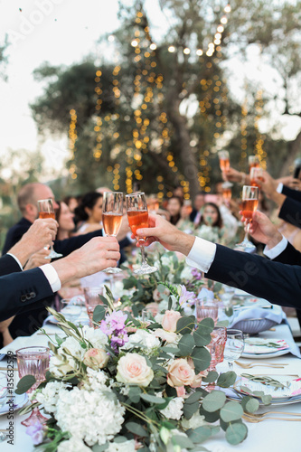 Guests at a wedding celebration toasting the couple