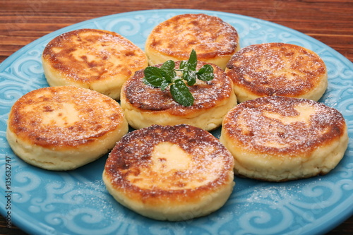 Cheese pancakes fried in a pan.