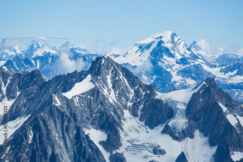Obraz premium Ice, snow, and glaciers cling to the sides of Mont Blanc in the french Alps