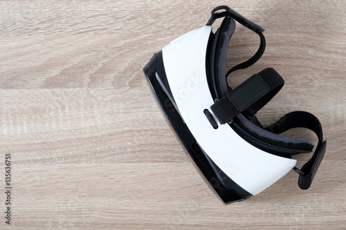 Top view VR virtual reality glasses  on wooden table