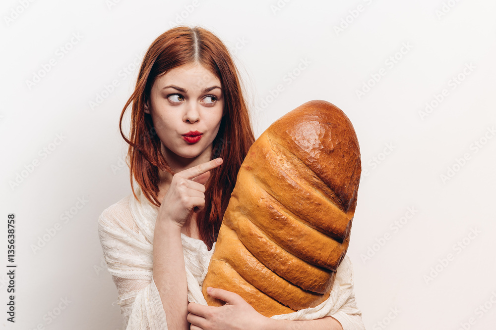 woman looking to the side and showing her finger on the loaf
