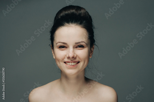 happy woman on gray background, beautiful smile