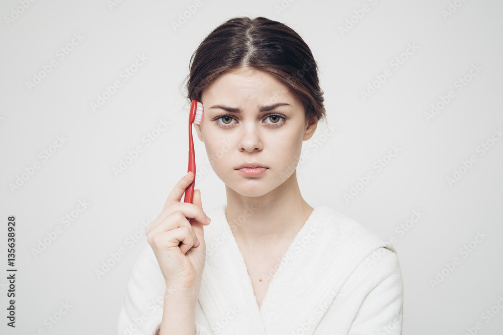 woman combing her hair with a toothbrush