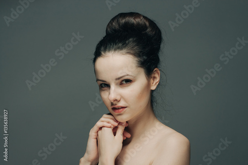 gray background and elegant woman with bare shoulders
