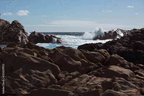 Waves Crash on ocean rocks 