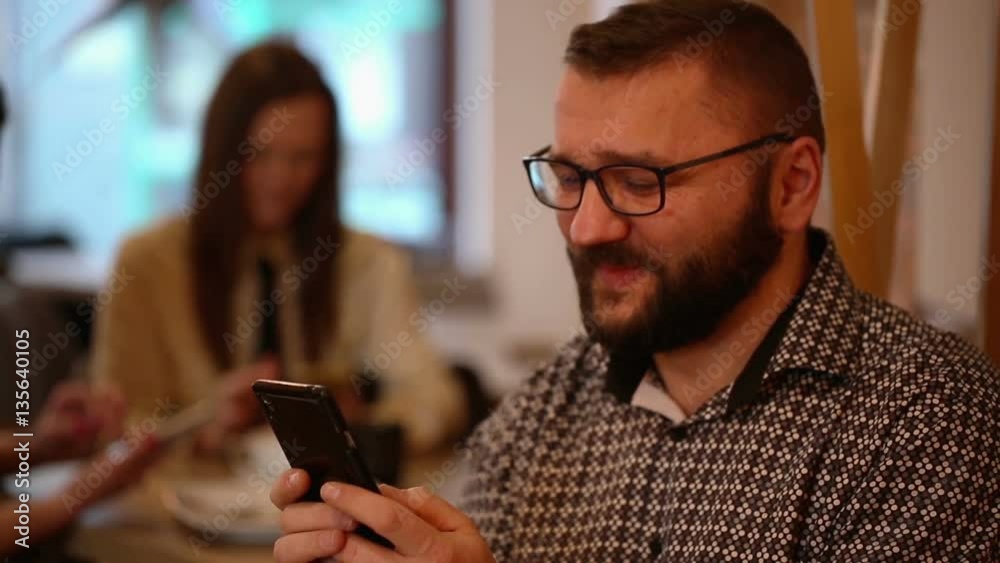 Man sending text message in restaurant
Man sending text message in restaurant