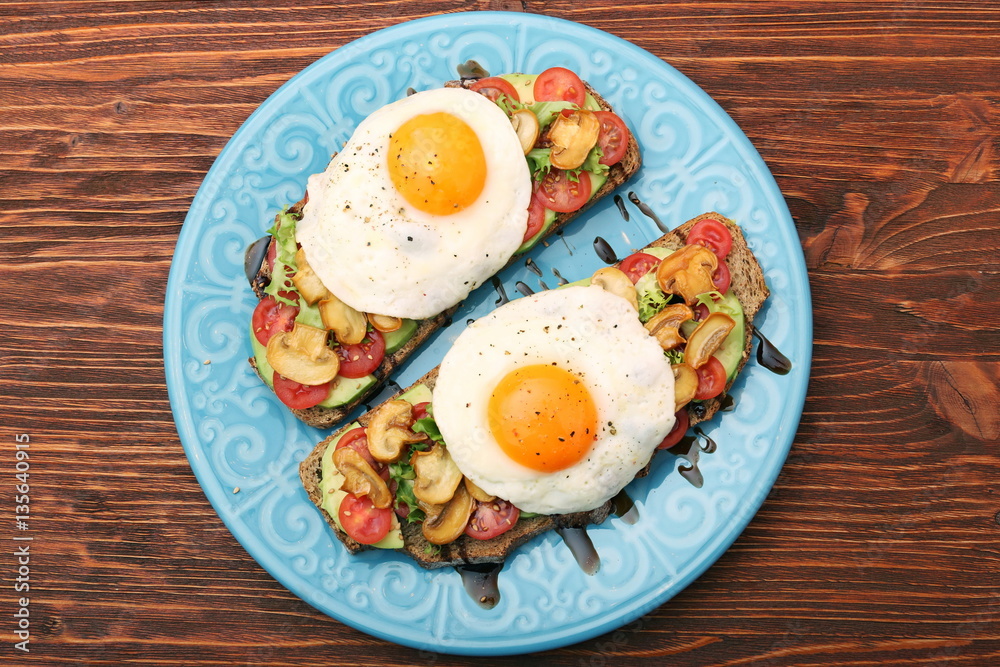 Sandwich with egg, tomato, greens, and mushrooms Sandwich with egg, tomato, greens, and mushrooms