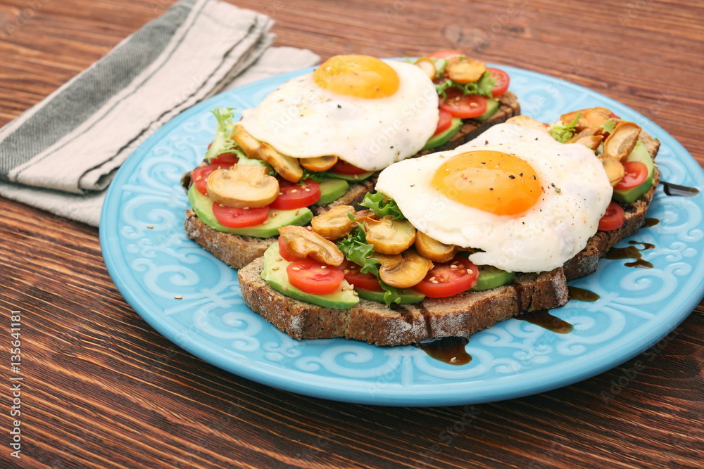 Sandwich with egg, tomato, greens, and mushrooms Sandwich with egg, tomato, greens, and mushrooms