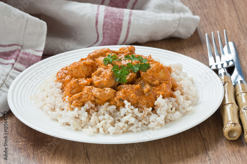 Chicken curry sauce / Chicken curry with brown rice in white plate on wooden background
