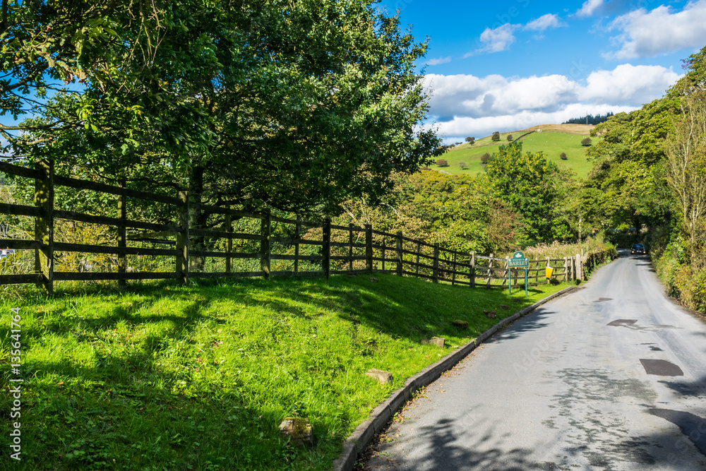 Fototapeta premium Countryside road, tarmac road, Summer, blue sky and white clouds, Forest Of Bowland, Lancashire, England, UK