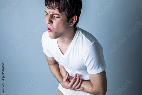 Tableau sur toile young man having a stomachache