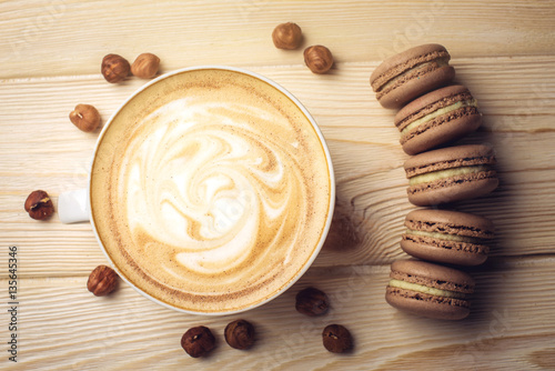Flavored coffee cappuccino with macarons and nuts. The perfect Breakfast
