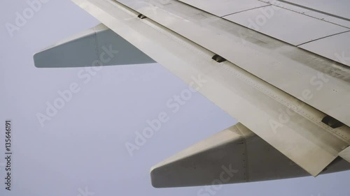 Wing and Engines of a Plane and Clouds Seen Through a Window While Flying
 photo