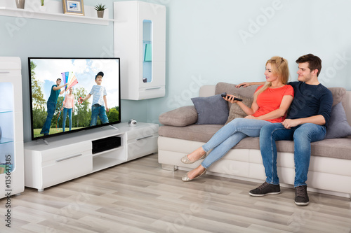 Couple Watching Movie On Television At Home