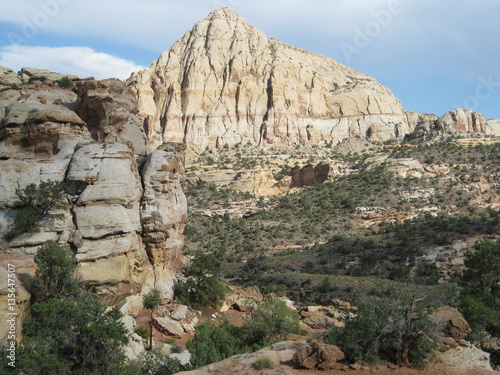 A sandstone cliff and another rock formation, Capitol Reef National Park, Utah