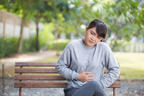 Woman has stomachache at park