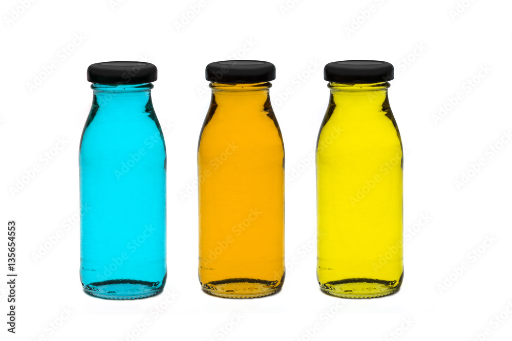 Three bottles of plum juice. Isolated on a white background. The bottle is reflected in the background. Three bottles of plum juice. Isolated on a white background. The bottle is reflected in the background.