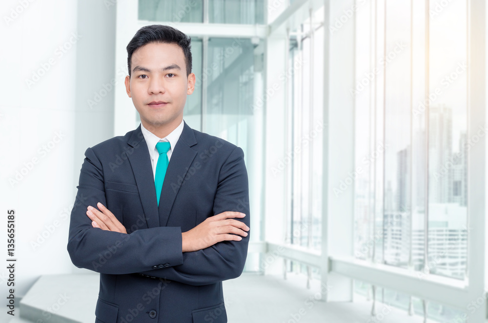 Handsome asian businessman standing in office Handsome asian businessman standing in office