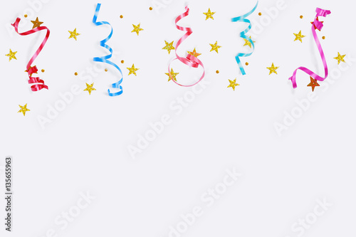 Colorful confetti stars, streamers on a light background.