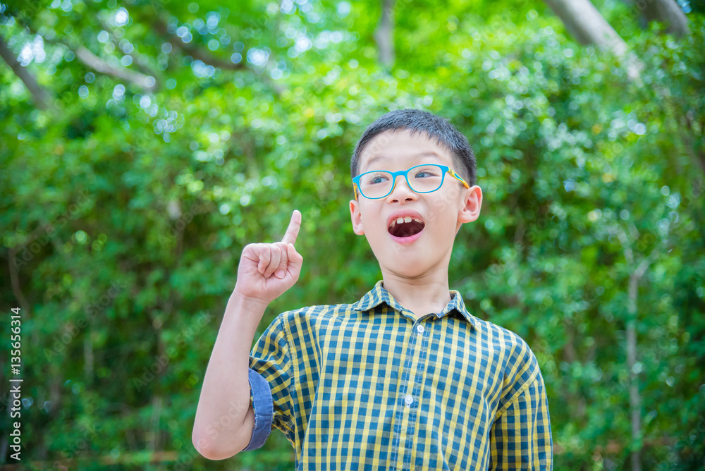 Young asian boy thinking in garden Young asian boy thinking in garden