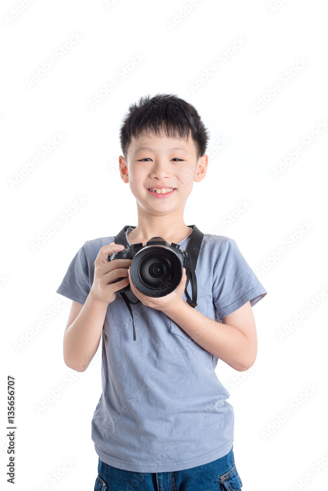 Young asian boy holding camera over white background Young asian boy holding camera over white background