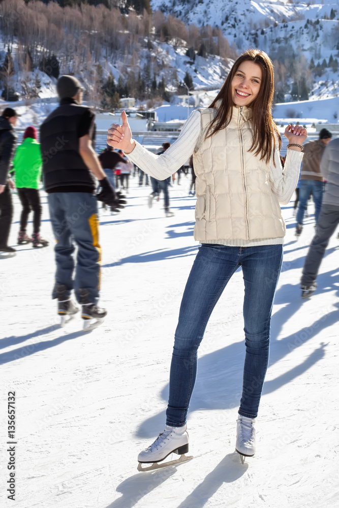 Pretty woman ice skating winter outdoors, smiling facial. mounta