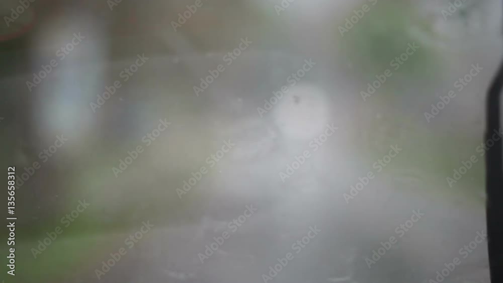 Windshield wipers moving back and forth during a rain storm Windshield wipers moving back and forth during a rain storm