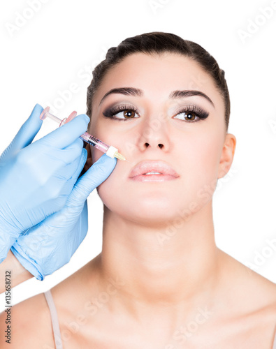 beautiful young woman face and syringe making injection. Isolated over white background.