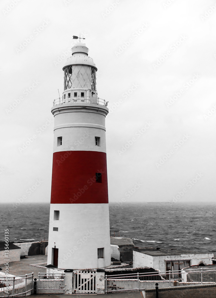 Vignette image of old lighthouse. Color in black and white.