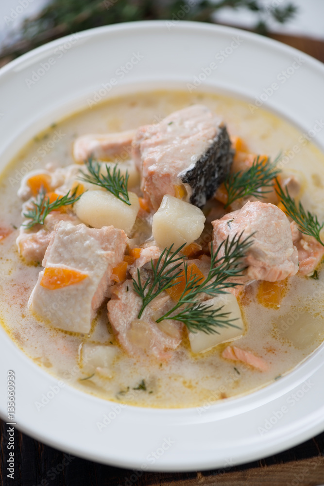 Close-up of finnic fish soup with salmon and vegetables