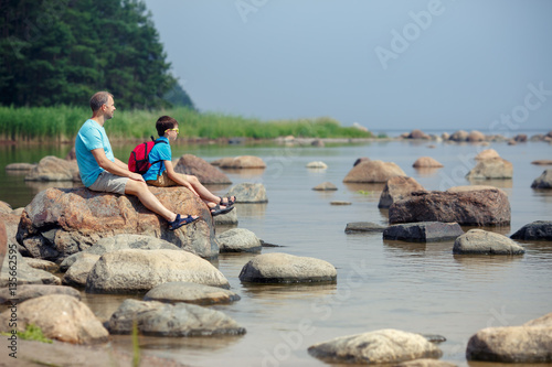 Family of two enjoying scenic view of rocks at the coast of Kasmu  Estonia