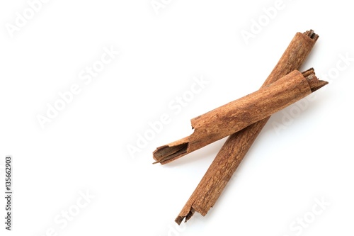 Top view of cinnamon sticks isolated on white