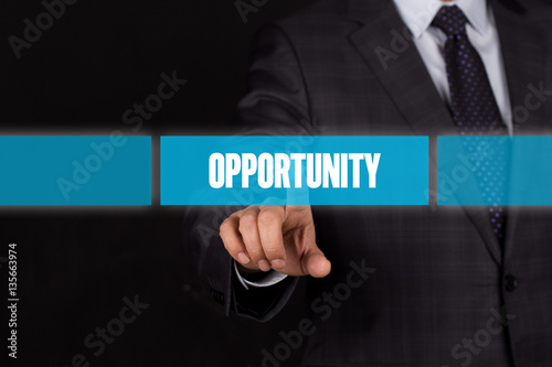 Hand pushing on a touch screen interface-OPPORTUNITY button