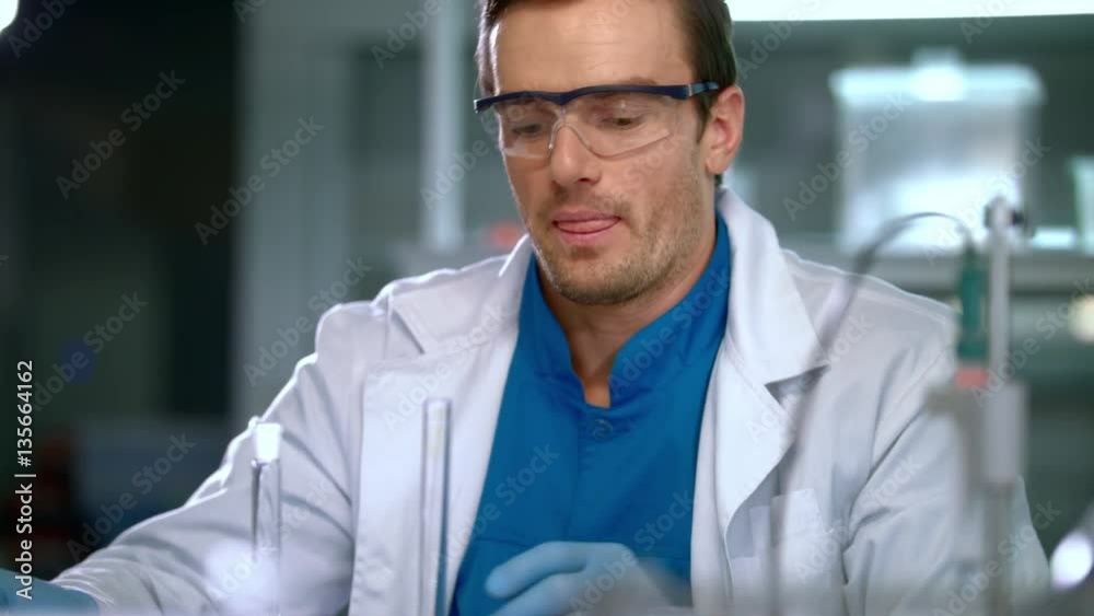 Researcher working with laboratory glassware. Lab worker working at lab with test tubes. Laboratory assistant preparing laboratory glassware for experiment. Male researcher preparing for research Researcher working with laboratory glassware. Lab worker working at lab with test tubes. Laboratory assistant preparing laboratory glassware for experiment. Male researcher preparing for research