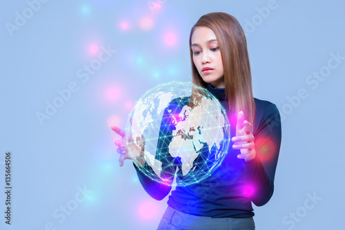 young woman looking at a abstract object floating on her hands, communication network concept.