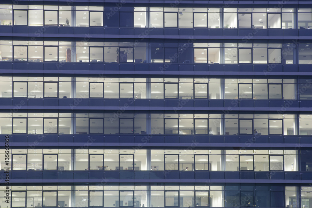 Fototapeta premium Modern office building facade at night