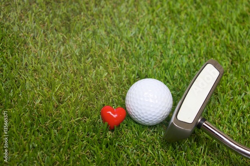 golf ball with love heart shape on green grass