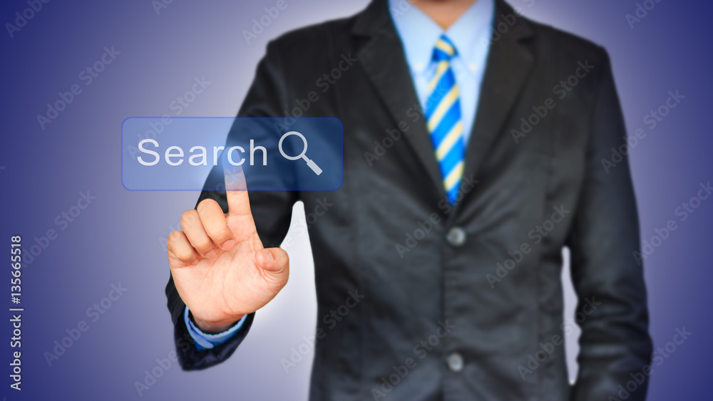 Business man pushing search botton on a touch screen interface Business man pushing search botton on a touch screen interface