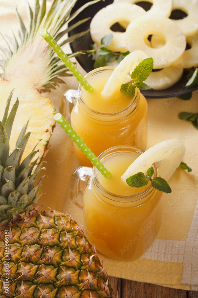 freshly squeezed pineapple juice in a glass jar closeup. vertical Stock