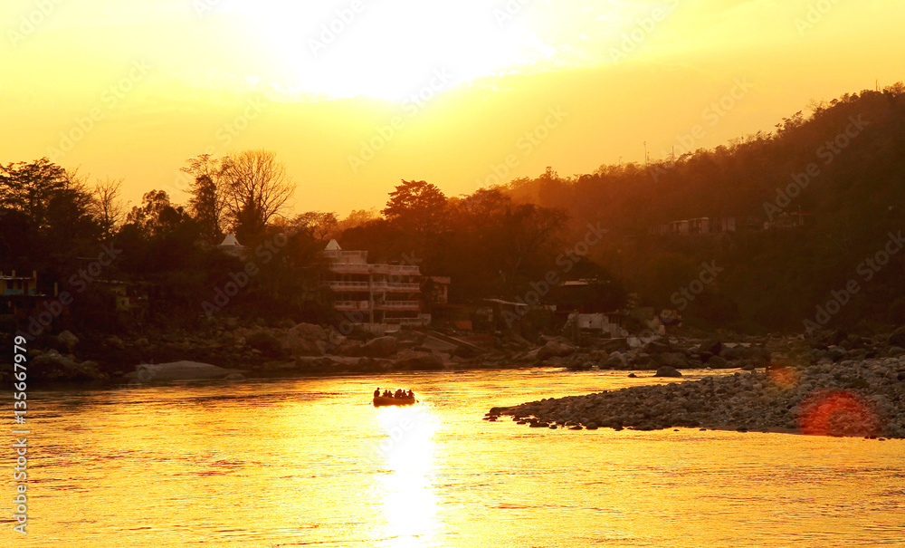 RISHIKESH, INDIA - sunset in Ganga river, boat rafting