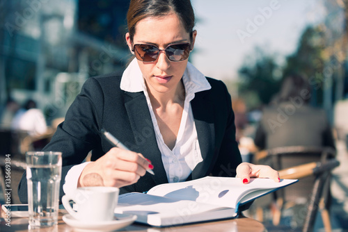 Businesswoman working in cafe