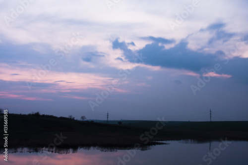 Field  river and beautiful sky and clouds reflected