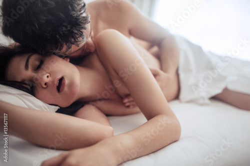Sensual lovers in bed having sex photo