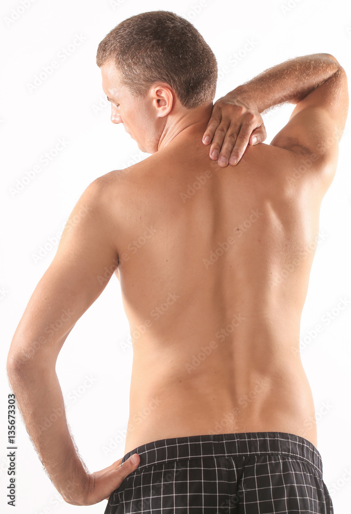 Studio shot of young man with pain in neck Studio shot of young man with pain in neck