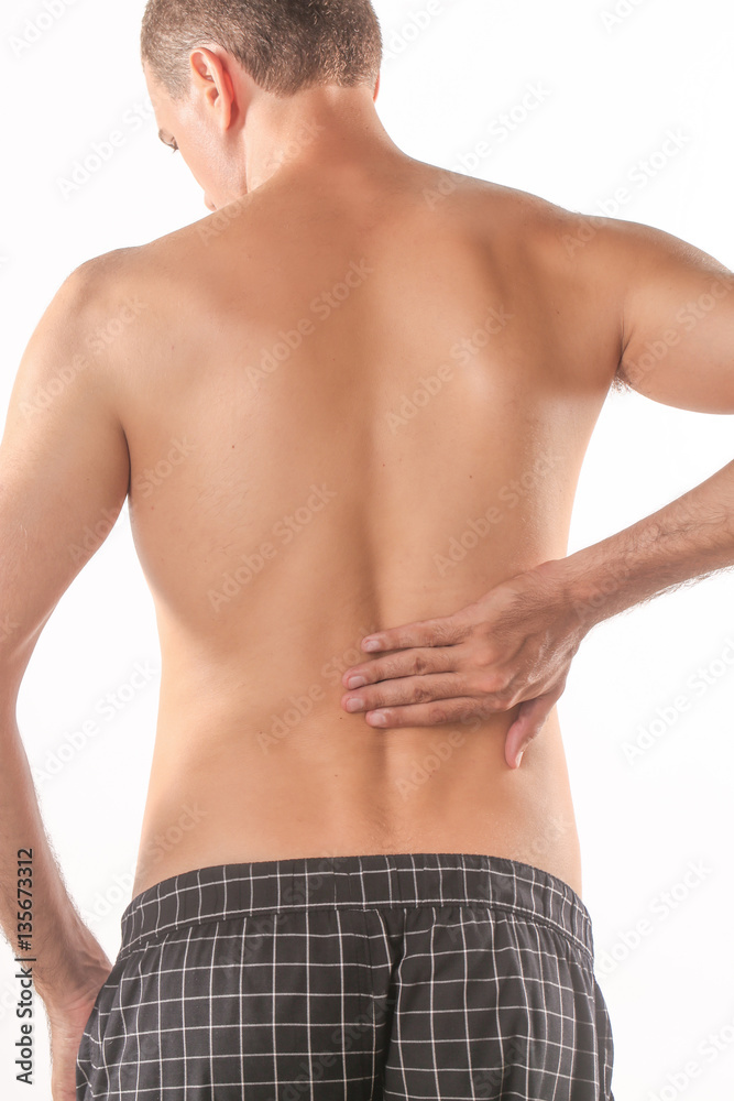 Studio shot of young man with pain in back