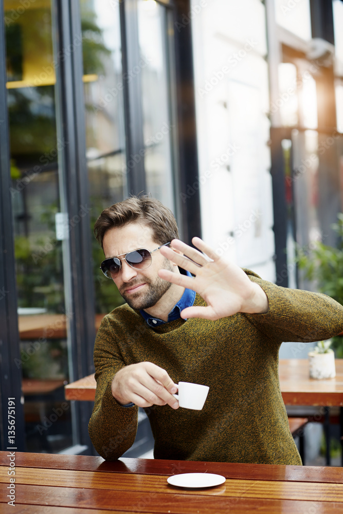 Celebrity gesturing over coffee