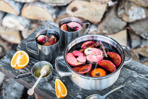 Hot mulled wine outdoor in a pot - winter or autumn picnic