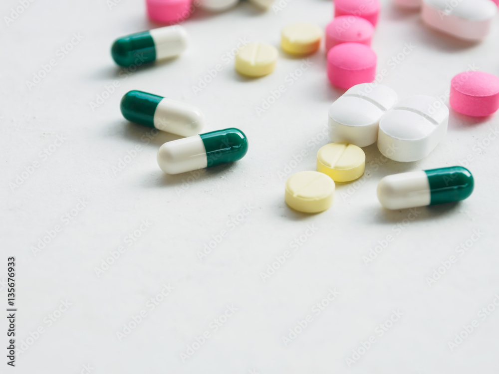 various medicine pill and capsule on white desk background various medicine pill and capsule on white desk background